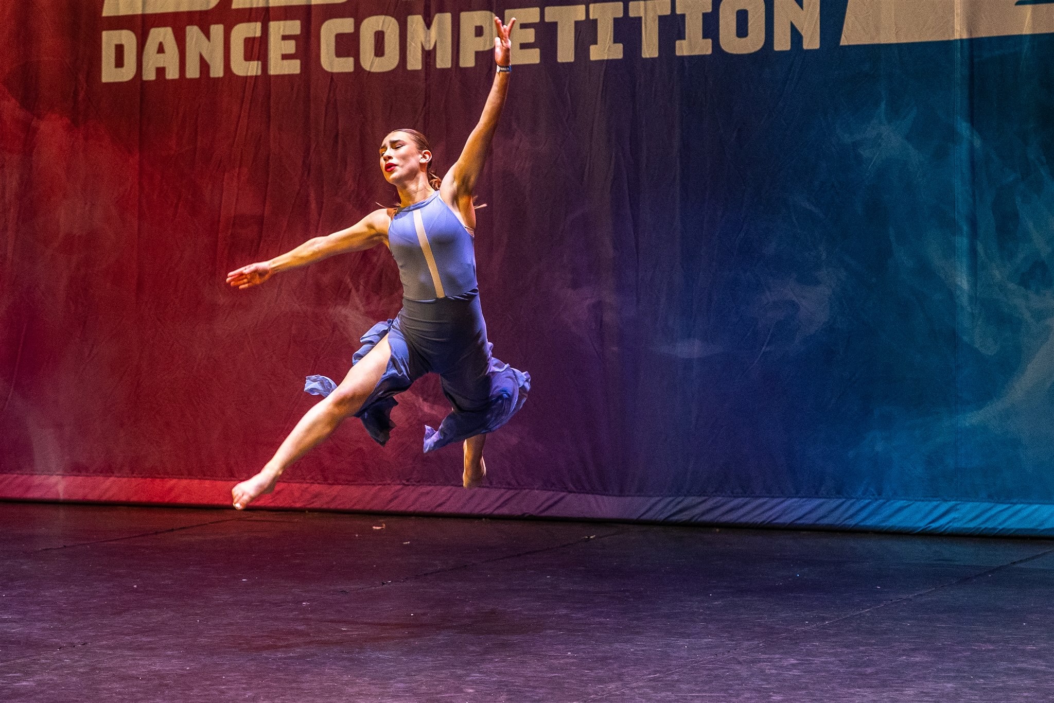 Dancer mid-leap at competition
