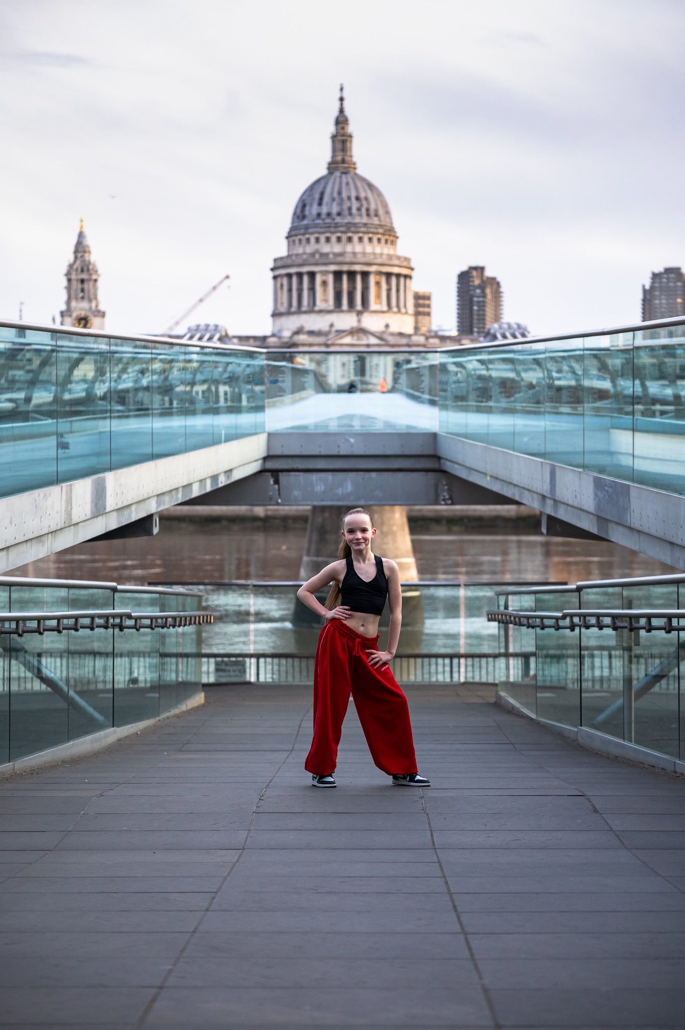 Dancer on Millennium Bridge with St Paul's Cathedral